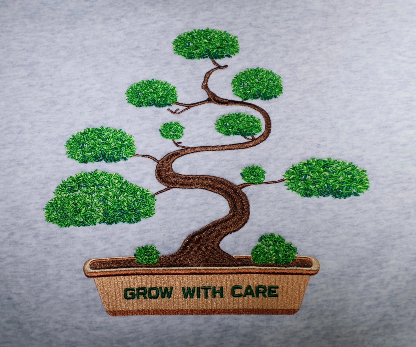 Bonsai embroidery detail on ‘Grow With Care’ Hoodie